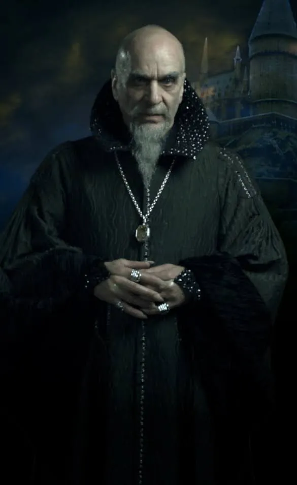 Winter founder's portrait composite: a bald man with a grey goatee in dark jeweled robes, hands clasped, with the castle behind him