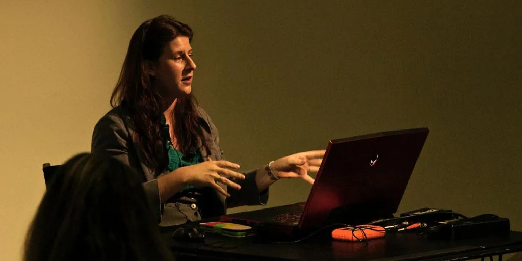 Mary Poplin presenting at a laptop to an audience